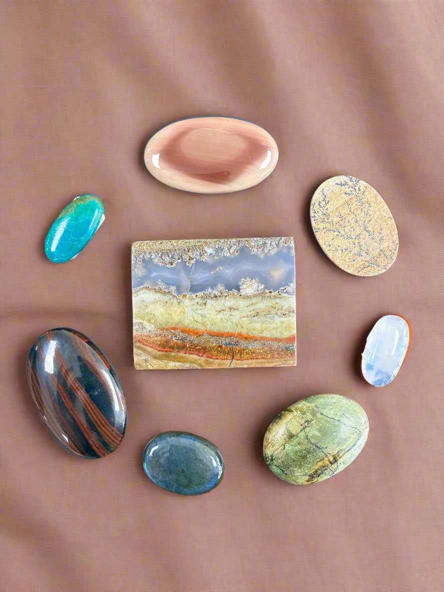 Collection of various stones on a wooden surface. 