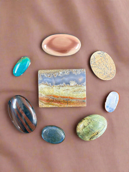 Collection of various stones on a wooden surface. 
